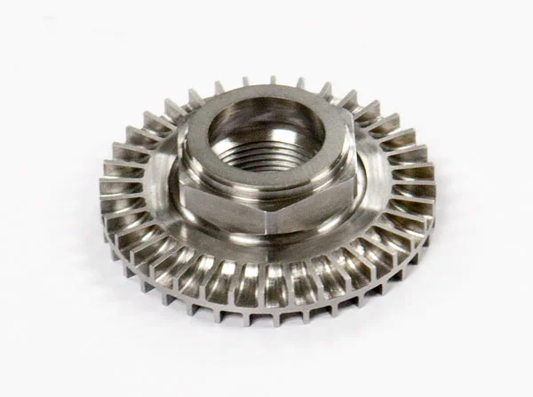 Stainless steel flanged hex nut with an integrated serrated or bevel gear ring around the circumference, featuring approximately 36 teeth, on white background.