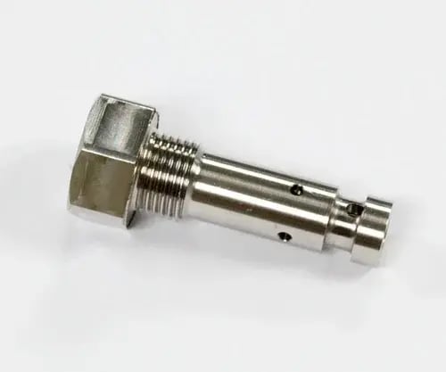 Nickel-plated hollow bolt with hex head, external threads, and two cross-drilled holes in the smooth shank, on white background.