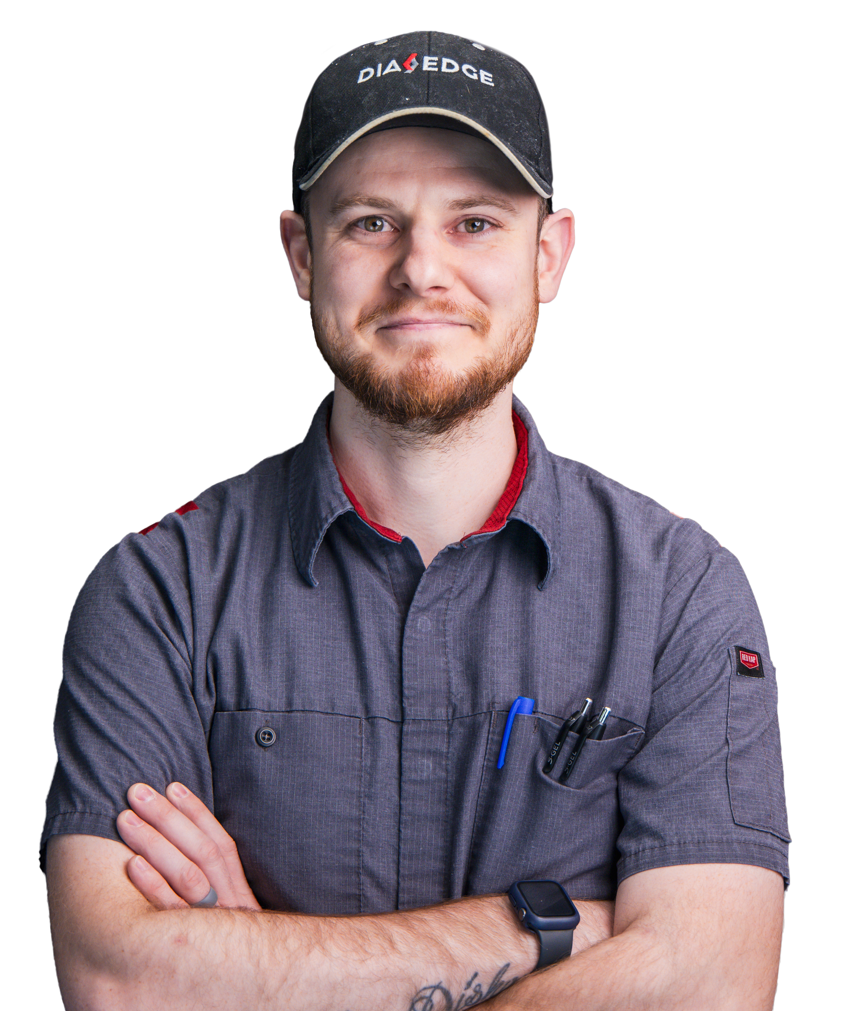 A Pointe Precision employee in a grey work shirt smiling with arms crossed.